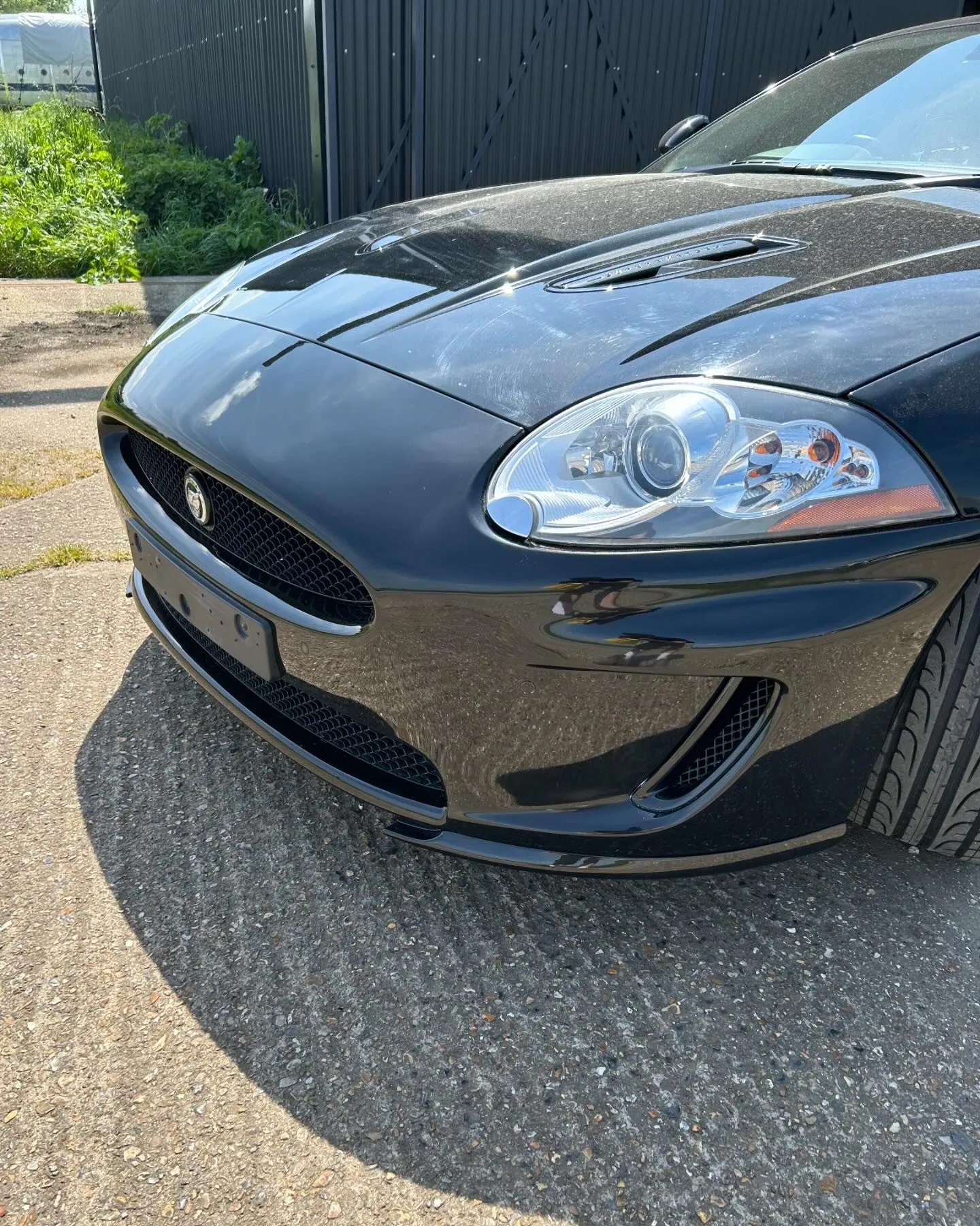 A black sports car parked in front of a building.